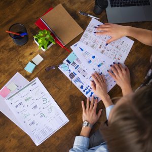top-view-women-working-together-office (1)
